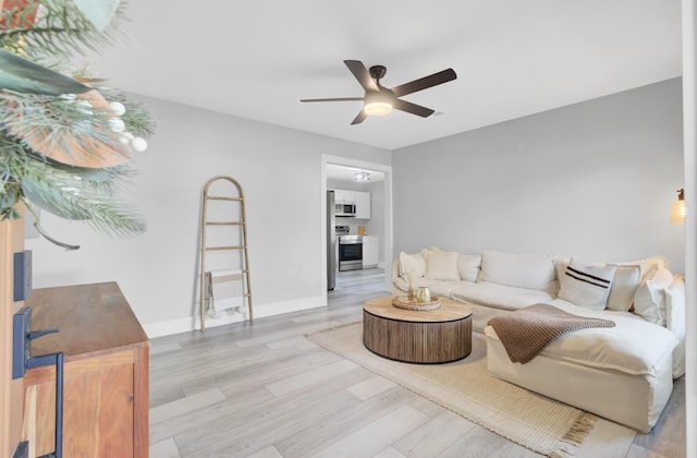 7674 Chippendale Rd, North Charleston, SC 29420 - living room featuring a ceiling fan, wood finished floors, and baseboards