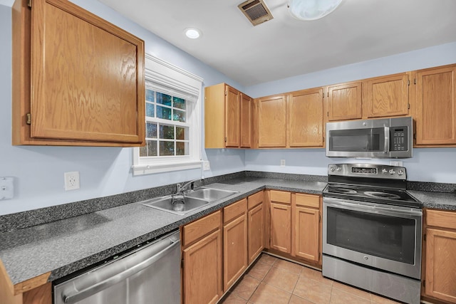 1309 Llewellyn Rd, Mount Pleasant, SC 29464 - kitchen featuring stainless steel appliances, a sink, dark countertops, and light tile patterned floors