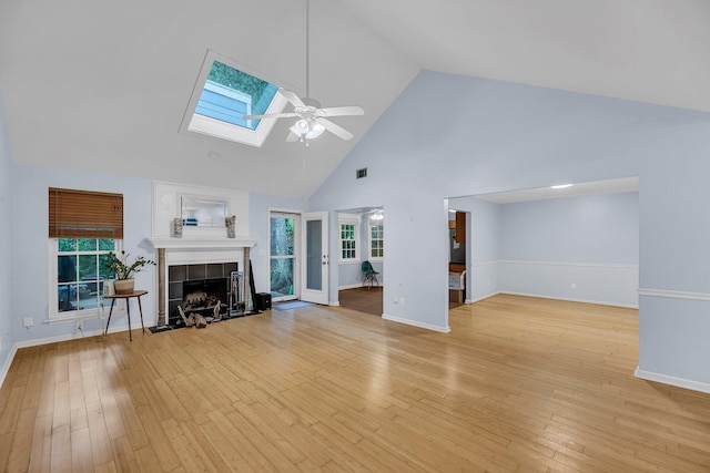 1309 Llewellyn Rd, Mount Pleasant, SC 29464 - unfurnished living room with high vaulted ceiling, ceiling fan, a fireplace, a skylight, and baseboards