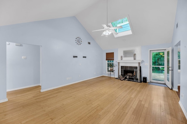 1309 Llewellyn Rd, Mount Pleasant, SC 29464 - unfurnished living room with high vaulted ceiling, a skylight, ceiling fan, a fireplace, and light wood finished floors
