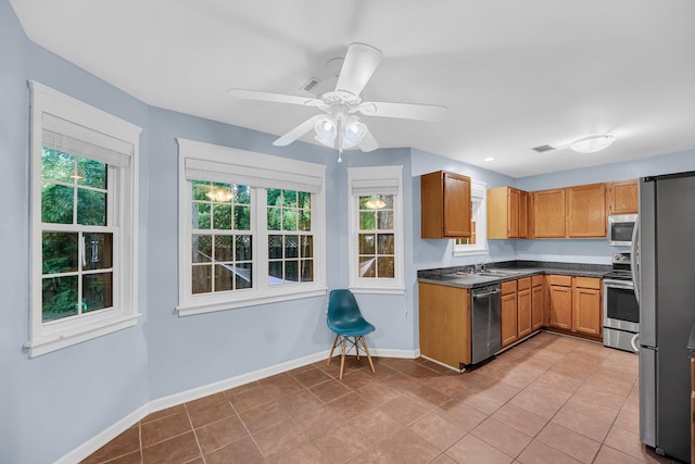 1309 Llewellyn Rd, Mount Pleasant, SC 29464 - kitchen with stainless steel appliances, plenty of natural light, baseboards, and light tile patterned floors