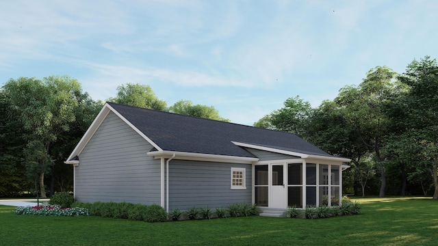 exterior space featuring a lawn, a sunroom, and a shingled roof