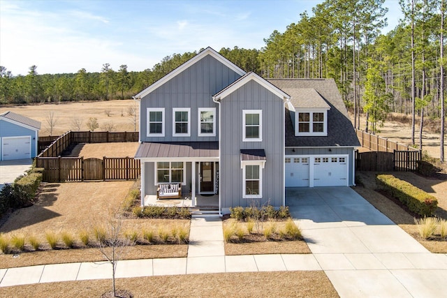 modern farmhouse style home featuring fence, roof with shingles, covered porch, concrete driveway, and board and batten siding