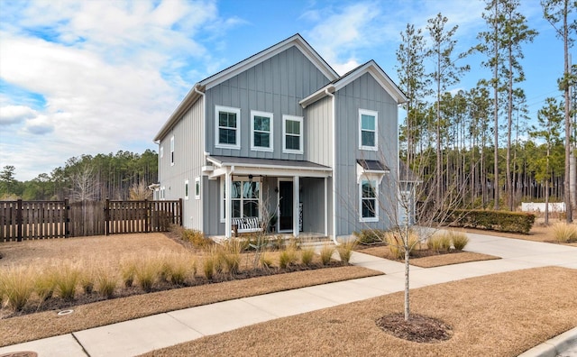 view of front of property with a porch, fence, and board and batten siding