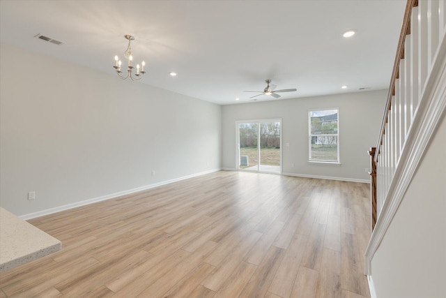 unfurnished living room with light wood-style floors, visible vents, stairway, and recessed lighting