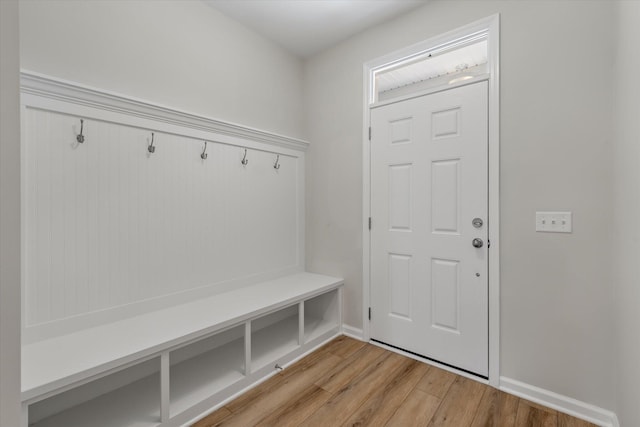 mudroom with light wood-style flooring and baseboards