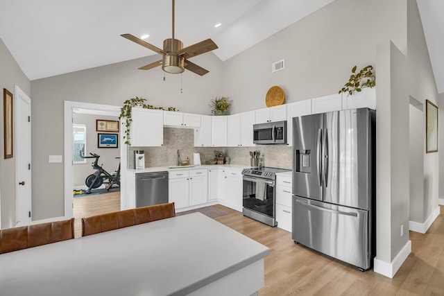 kitchen with light countertops, visible vents, appliances with stainless steel finishes, white cabinetry, and a sink