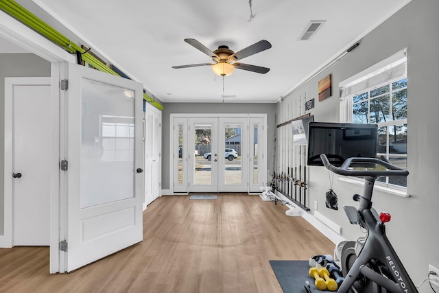 workout area with french doors, visible vents, ceiling fan, and light wood finished floors