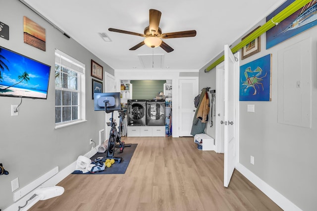 workout room featuring ceiling fan, visible vents, baseboards, light wood-style floors, and attic access