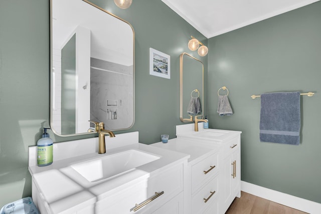 full bathroom featuring vanity, baseboards, and wood finished floors