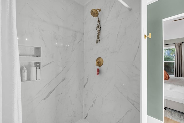 interior details featuring a marble finish shower and ensuite bathroom