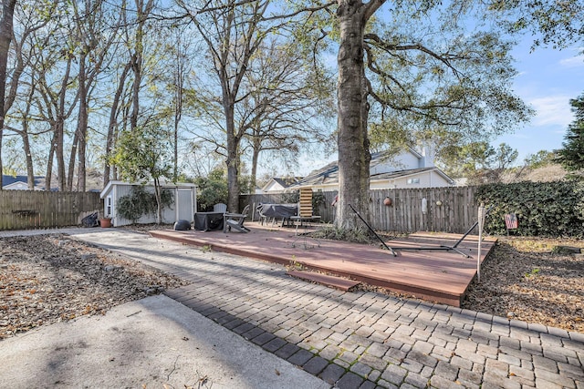 exterior space with a fenced backyard and an outbuilding