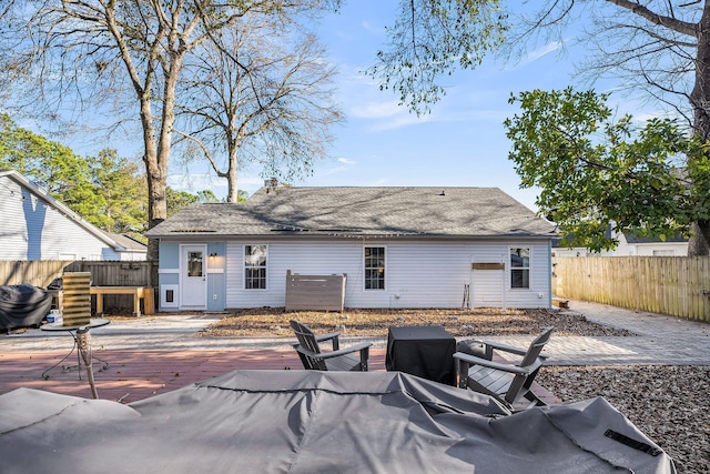 back of property featuring a fenced backyard and a patio