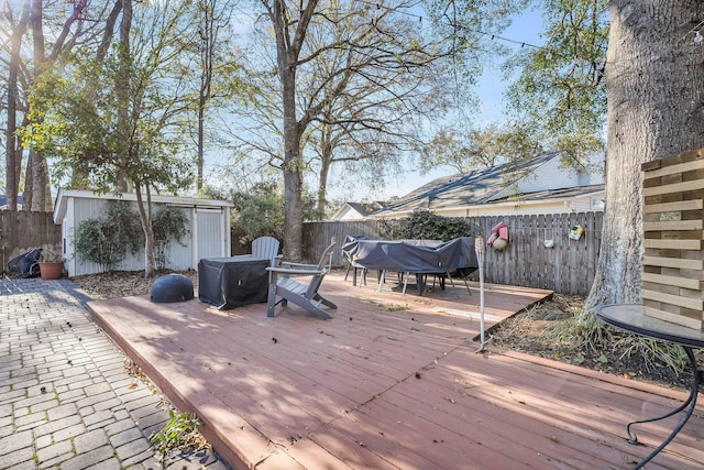 deck featuring an outbuilding and a fenced backyard