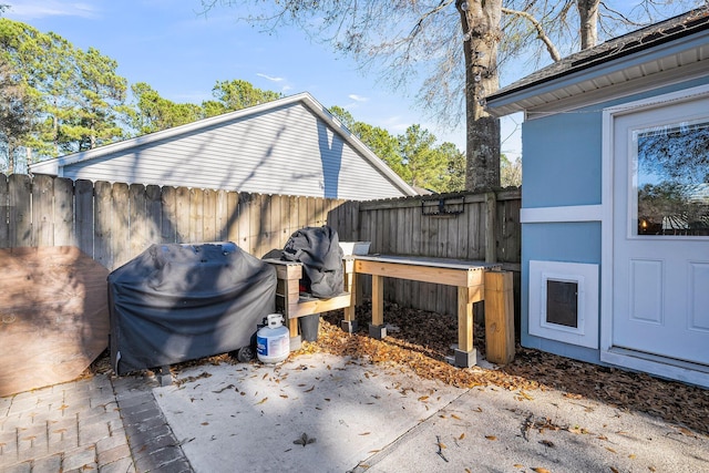 view of patio / terrace with a fenced backyard and a grill