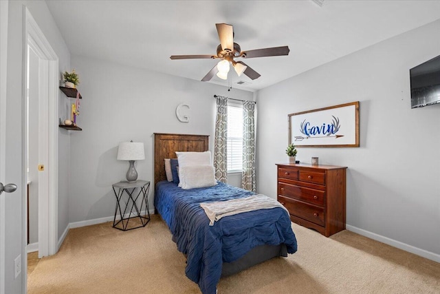 bedroom with light carpet, baseboards, and a ceiling fan