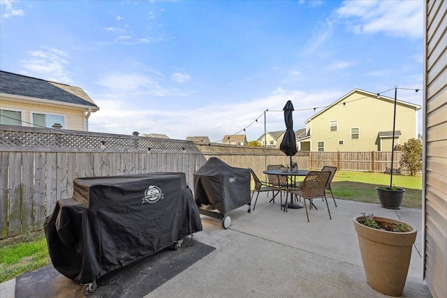 view of patio / terrace with a grill, a fenced backyard, and outdoor dining space