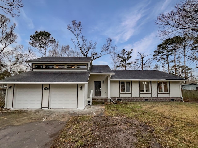 view of front of property featuring a front yard and a garage