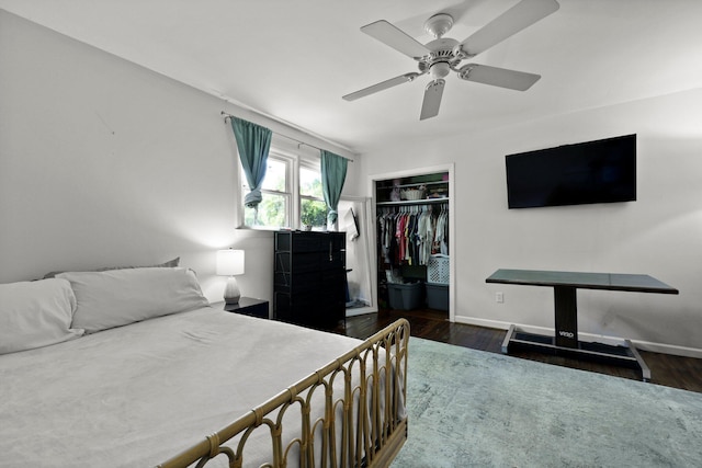 bedroom featuring baseboards, a ceiling fan, wood finished floors, and a closet