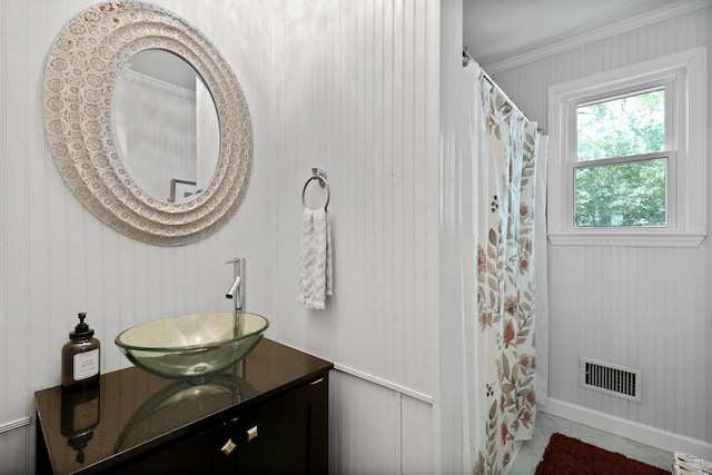 bathroom featuring crown molding, vanity, and visible vents