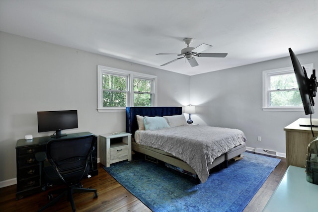 bedroom with wood finished floors, multiple windows, and visible vents