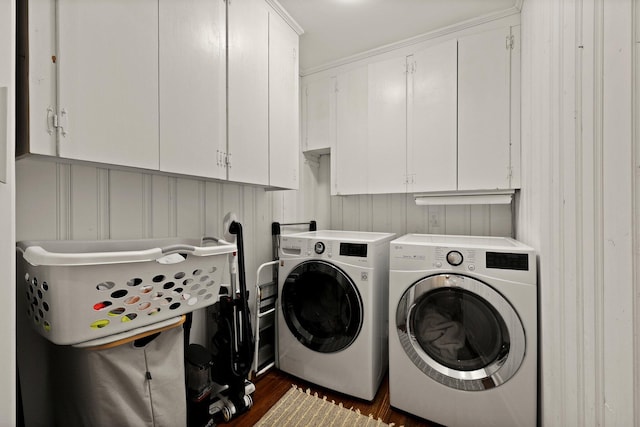 laundry area featuring cabinet space, dark wood-type flooring, and separate washer and dryer