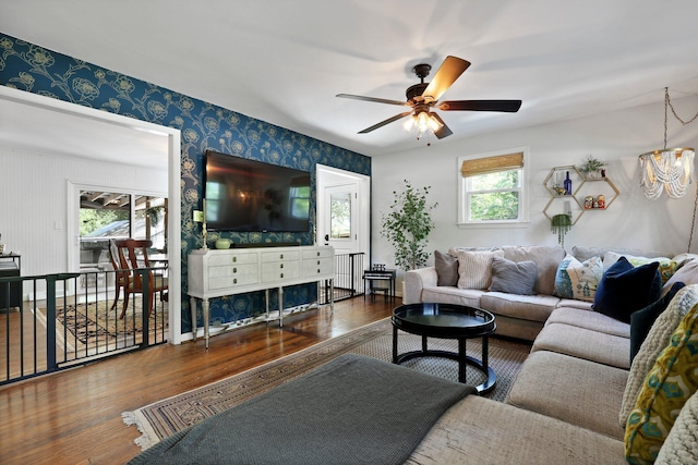 living area with wallpapered walls, wood finished floors, and a wealth of natural light