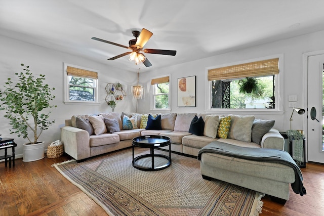 living room with plenty of natural light, a ceiling fan, and wood finished floors