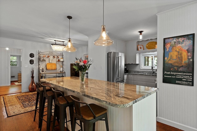 kitchen featuring a wealth of natural light, high quality fridge, and dark wood-type flooring
