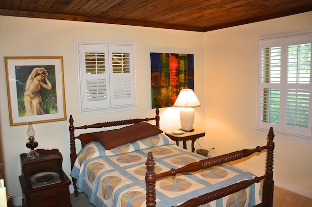 carpeted bedroom with wooden ceiling