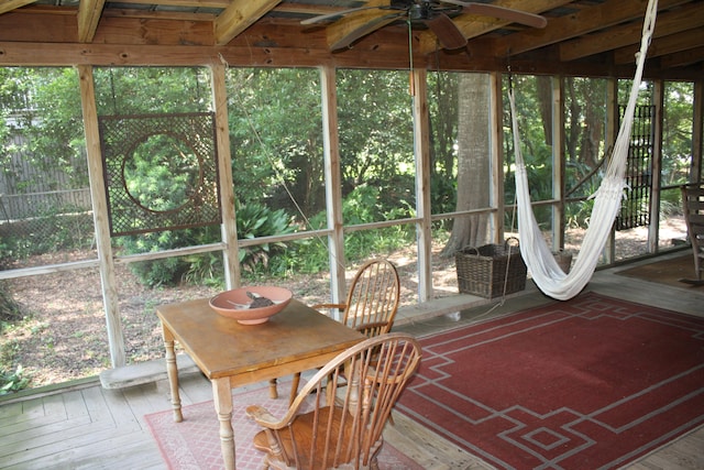 unfurnished sunroom featuring ceiling fan