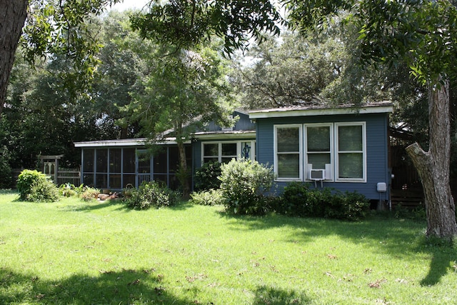 back of property featuring a lawn and cooling unit