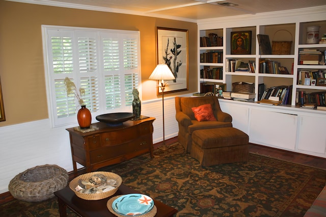 sitting room featuring ornamental molding and hardwood / wood-style flooring