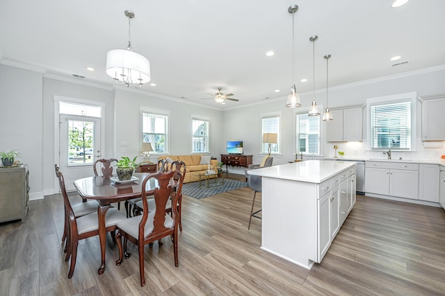 kitchen featuring a wealth of natural light, a sink, light countertops, and recessed lighting