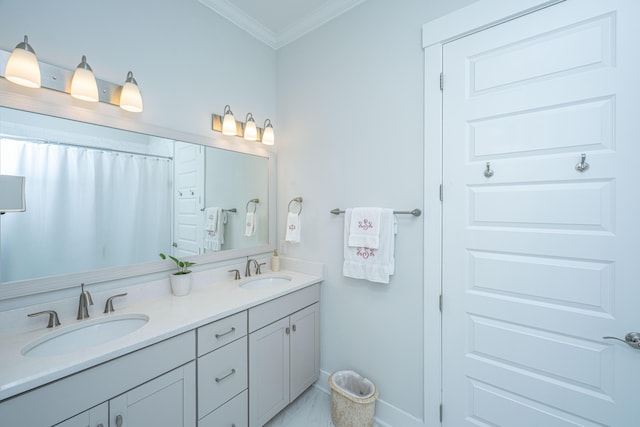 full bath with marble finish floor, baseboards, crown molding, and a sink