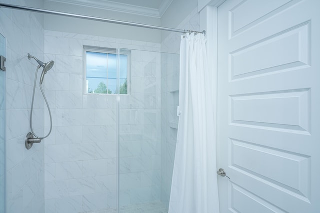 full bath with a shower stall and ornamental molding