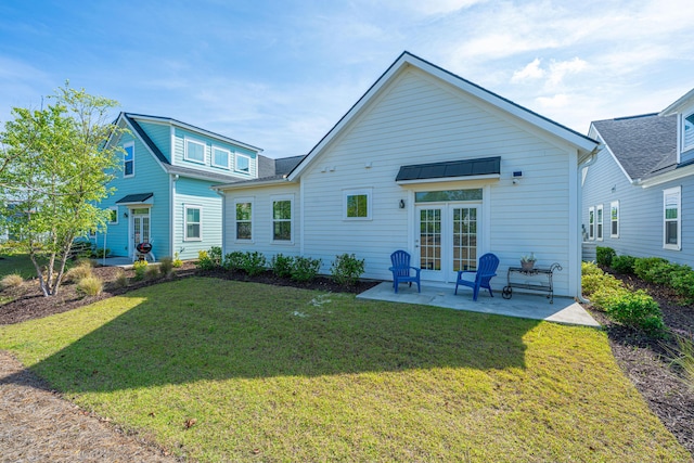 rear view of property featuring a lawn and a patio