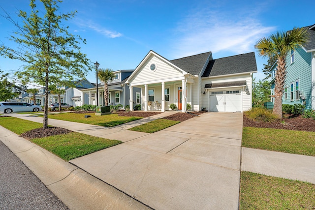 view of front facade with a front lawn, driveway, covered porch, a garage, and a shingled roof