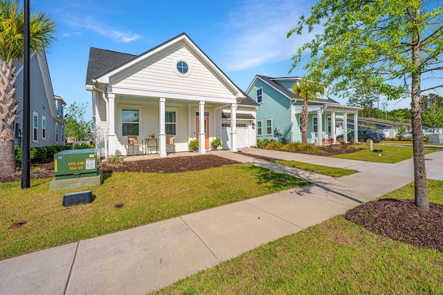 view of front of house with concrete driveway, an attached garage, a porch, and a front yard