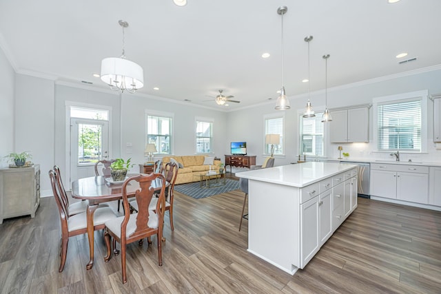 kitchen with recessed lighting, dishwasher, wood finished floors, and a sink