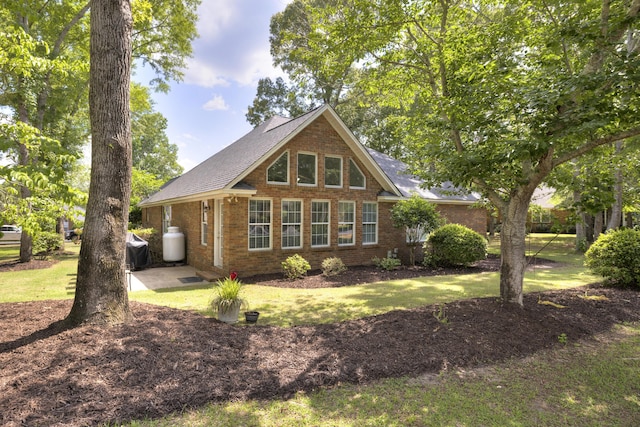256 Ridge Lake Dr, Manning, SC 29102 - view of front of house featuring brick siding, a front lawn, and roof with shingles
