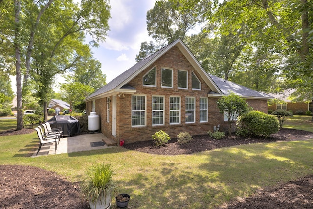256 Ridge Lake Dr, Manning, SC 29102 - back of property featuring a patio, brick siding, and a lawn