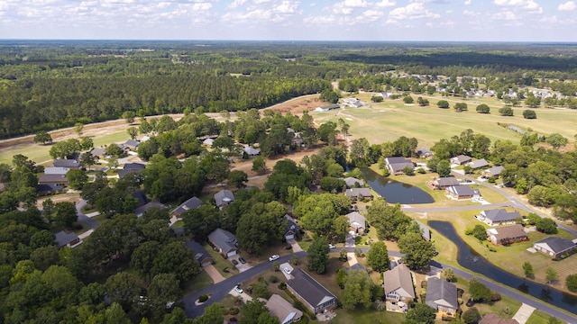 256 Ridge Lake Dr, Manning, SC 29102 - aerial view of property and surrounding area with a heavily wooded area, nearby suburban area, and a nearby body of water