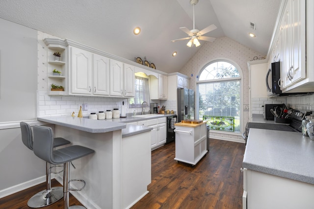 256 Ridge Lake Dr, Manning, SC 29102 - kitchen with open shelves, a sink, white cabinets, a peninsula, and ceiling fan