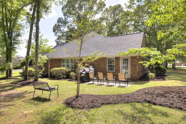 256 Ridge Lake Dr, Manning, SC 29102 - rear view of house with a patio, a yard, roof with shingles, and brick siding