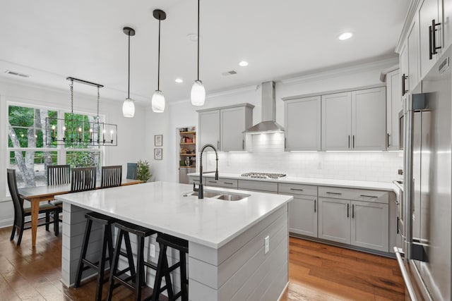 233 Camber Rd, Huger, SC 29450 - kitchen with appliances with stainless steel finishes, wall chimney range hood, gray cabinetry, an island with sink, and backsplash