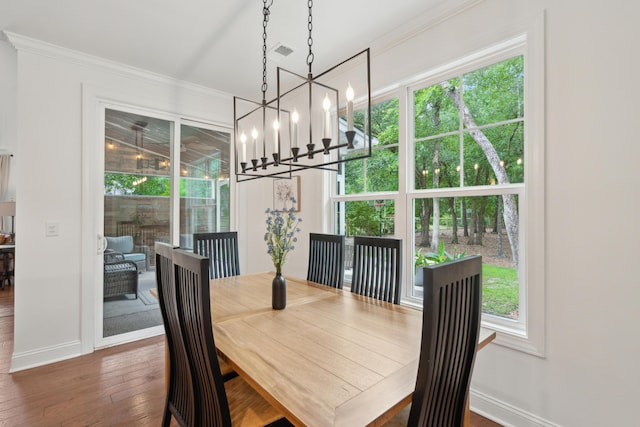 233 Camber Rd, Huger, SC 29450 - dining room featuring healthy amount of natural light, ornamental molding, wood-type flooring, and a chandelier