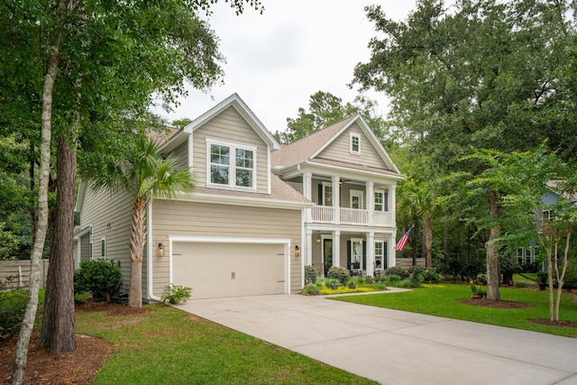 233 Camber Rd, Huger, SC 29450 - neoclassical / greek revival house with a balcony, driveway, a front yard, an attached garage, and a ceiling fan