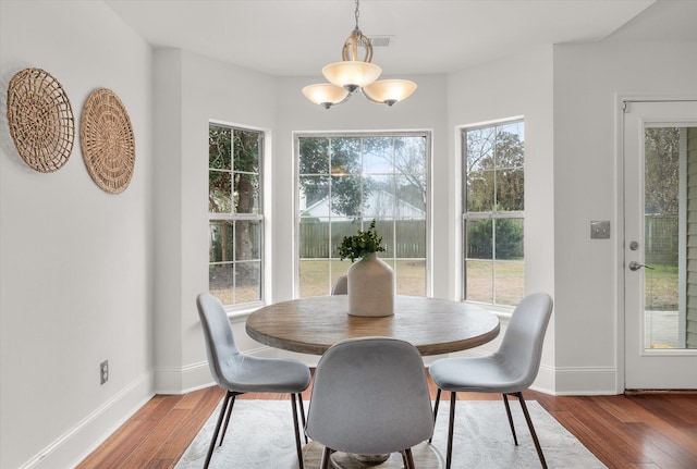 dining area featuring a chandelier and hardwood / wood-style floors