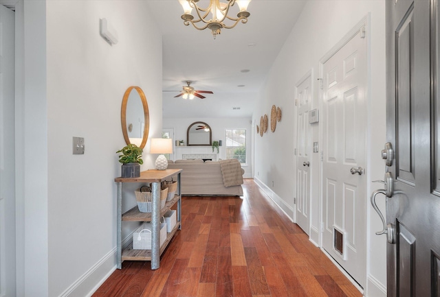 corridor with a chandelier and dark hardwood / wood-style flooring